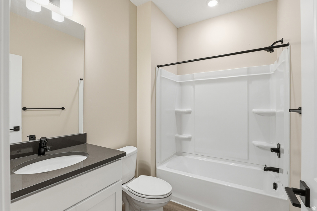 Bathroom featuring a white vanity with dark countertop, undermount sink, and matte black faucet