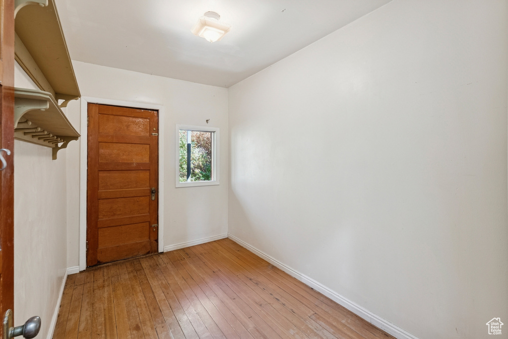 Empty room with light wood-style floors and baseboards