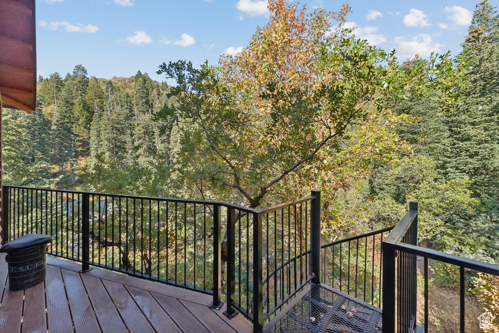 Wooden terrace featuring a forest view