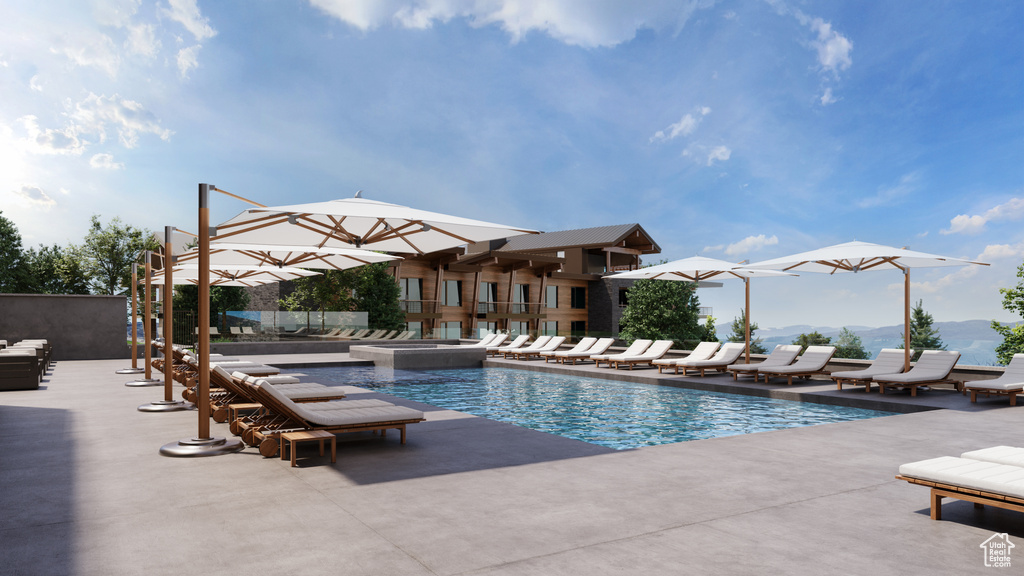 Community pool featuring a mountain view, an in-ground hot tub, and a patio