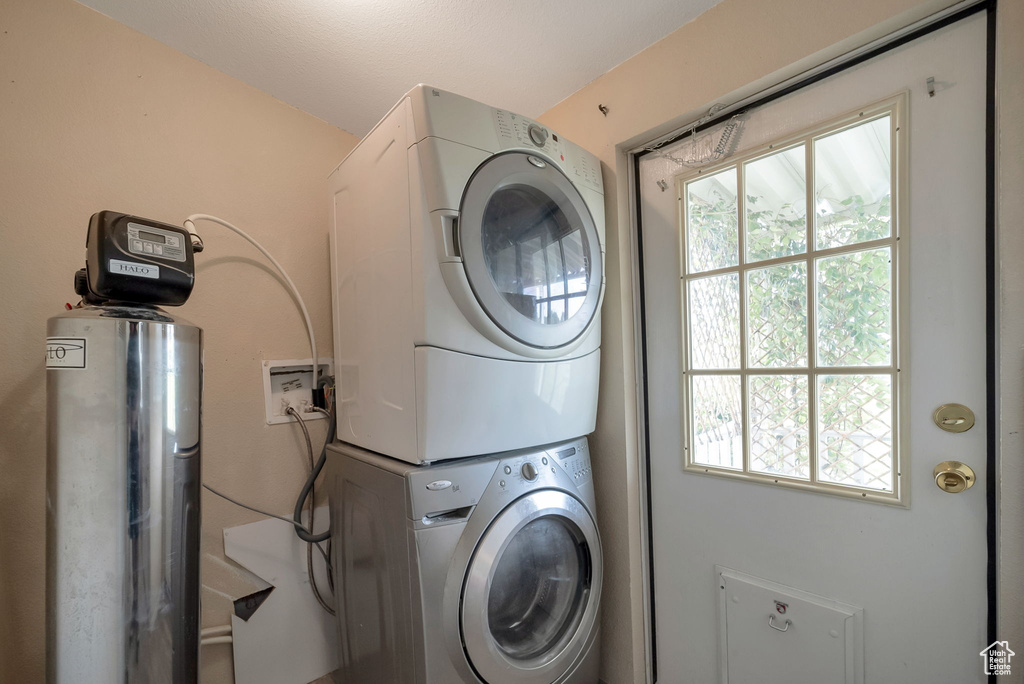 Laundry room with stacked washer and clothes dryer