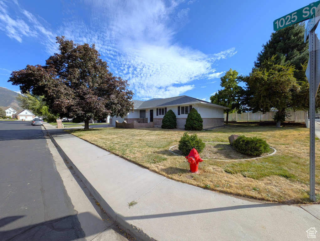 Ranch-style home featuring concrete driveway and an attached garage