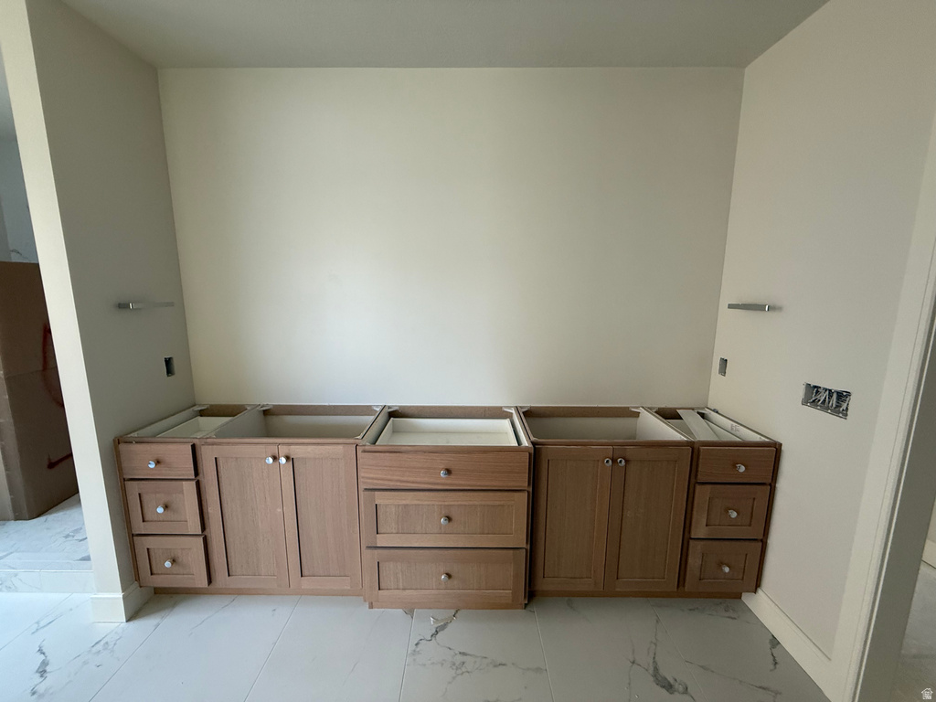 Bathroom featuring light marble finish floors and a tub to relax in