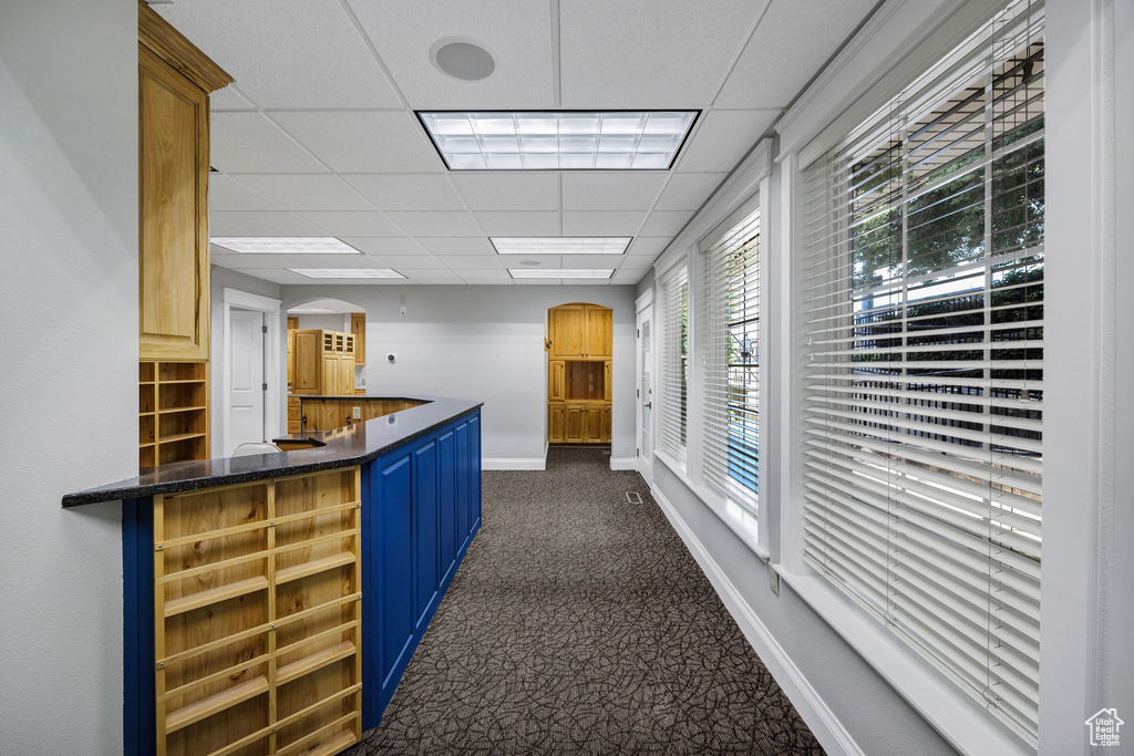 Reception area featuring a paneled ceiling and arched walkways