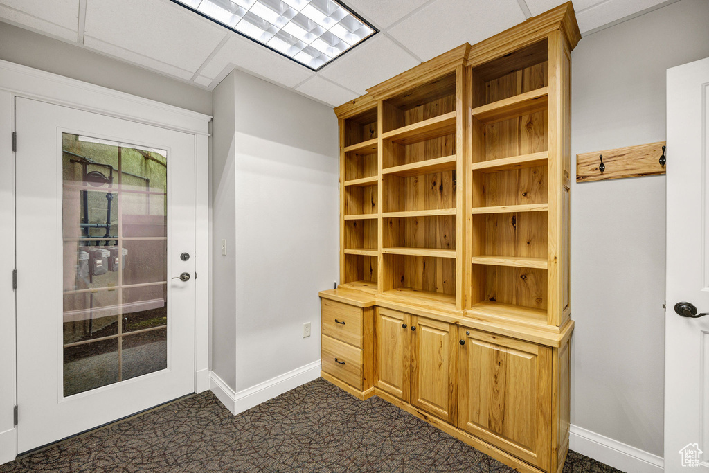 Mudroom with a paneled ceiling and dark colored carpet
