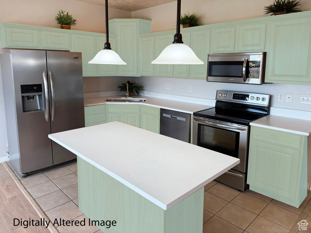 Kitchen with stainless steel appliances, a center island, light tile patterned floors, and green cabinets