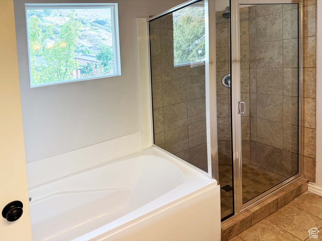 Full bathroom with a garden tub, a shower stall, and tile patterned floors