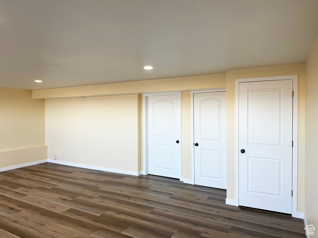 Unfurnished bedroom with recessed lighting and dark wood-type flooring