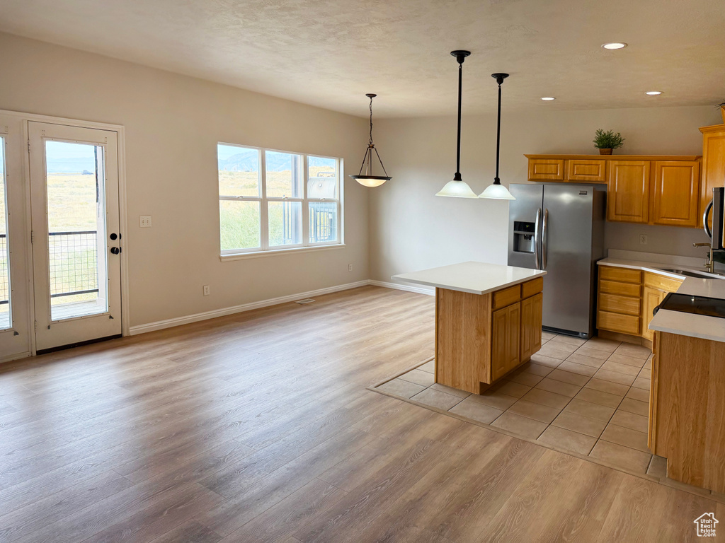 Kitchen featuring stainless steel appliances, light countertops, light wood-type flooring, and recessed lighting