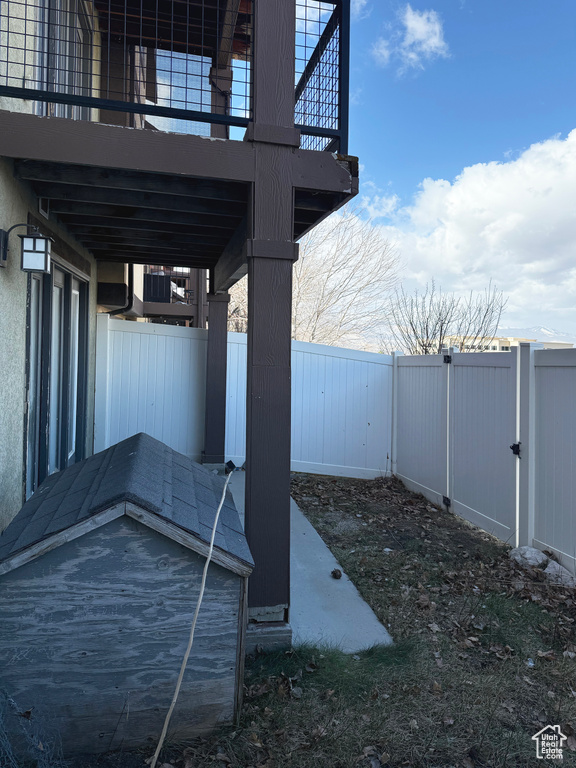 Fenced backyard with a balcony and a patio