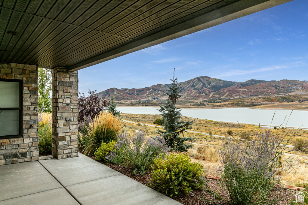 View of patio / terrace featuring a water and mountain view