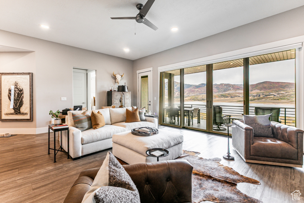 Living room featuring a mountain view, recessed lighting, wood finished floors, and a ceiling fan