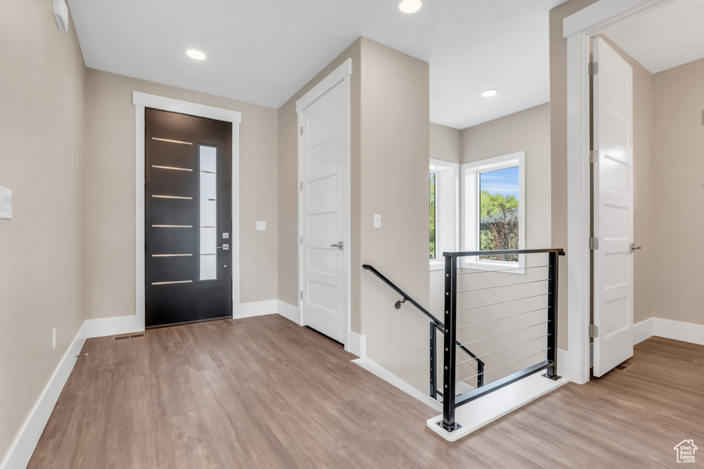 Entryway with light wood-style floors and recessed lighting
