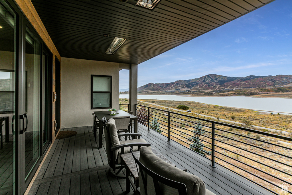 Wooden terrace with a water and mountain view