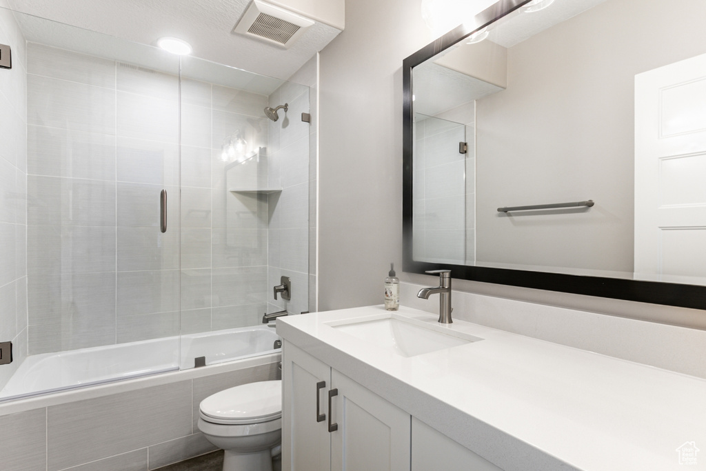 Bathroom with tiled shower / bath combo and vanity