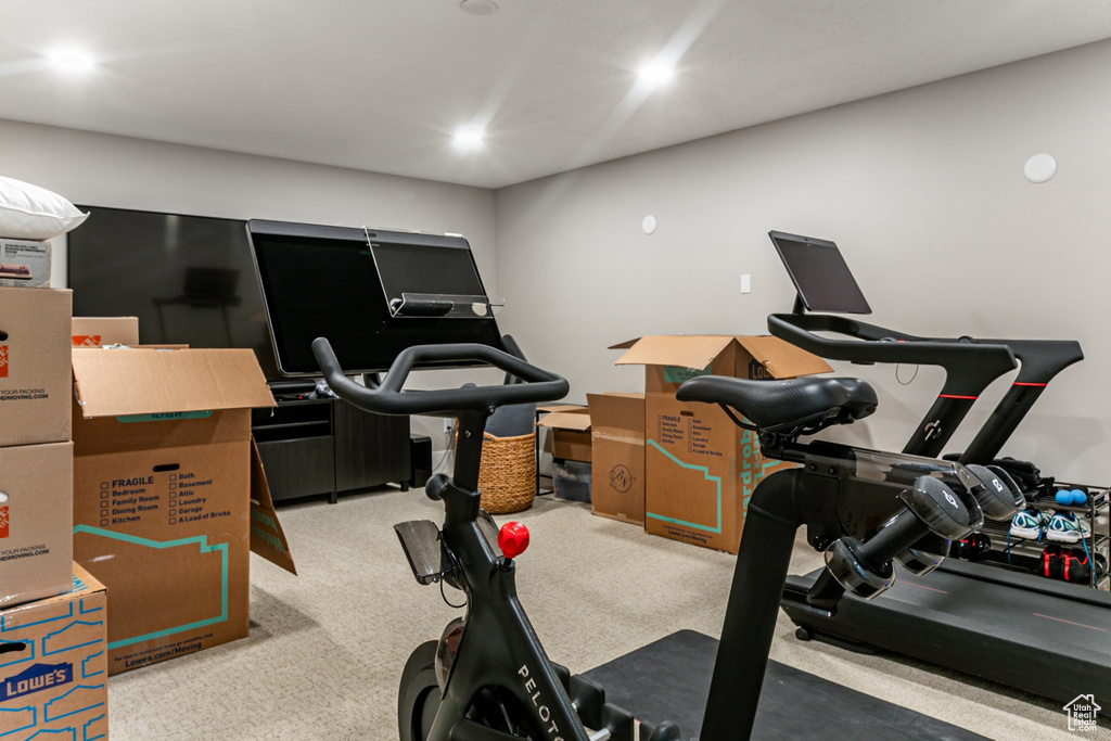 Workout area with light colored carpet