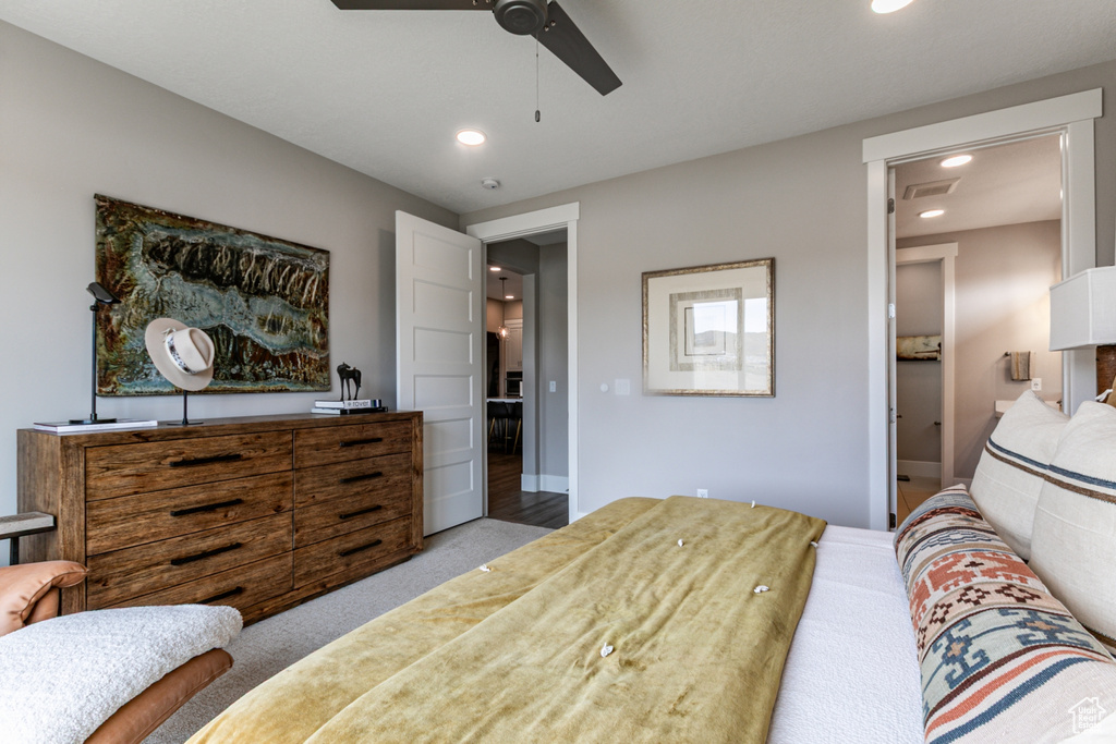 Bedroom with light colored carpet, connected bathroom, recessed lighting, and a ceiling fan