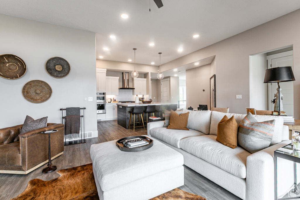 Living room with dark wood-style flooring, recessed lighting, and a ceiling fan