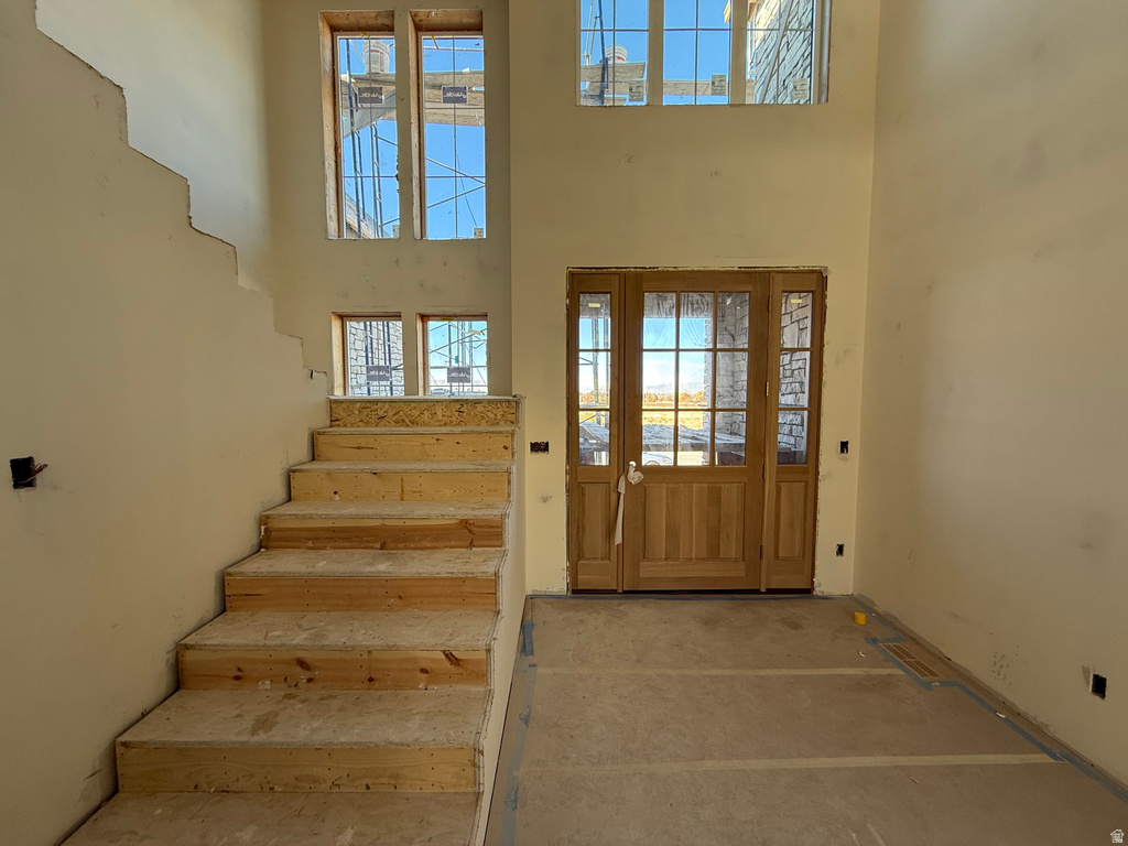 Foyer featuring stairs and a high ceiling
