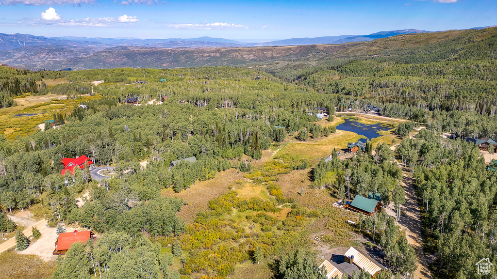 View of property location featuring a forest and a mountainous background