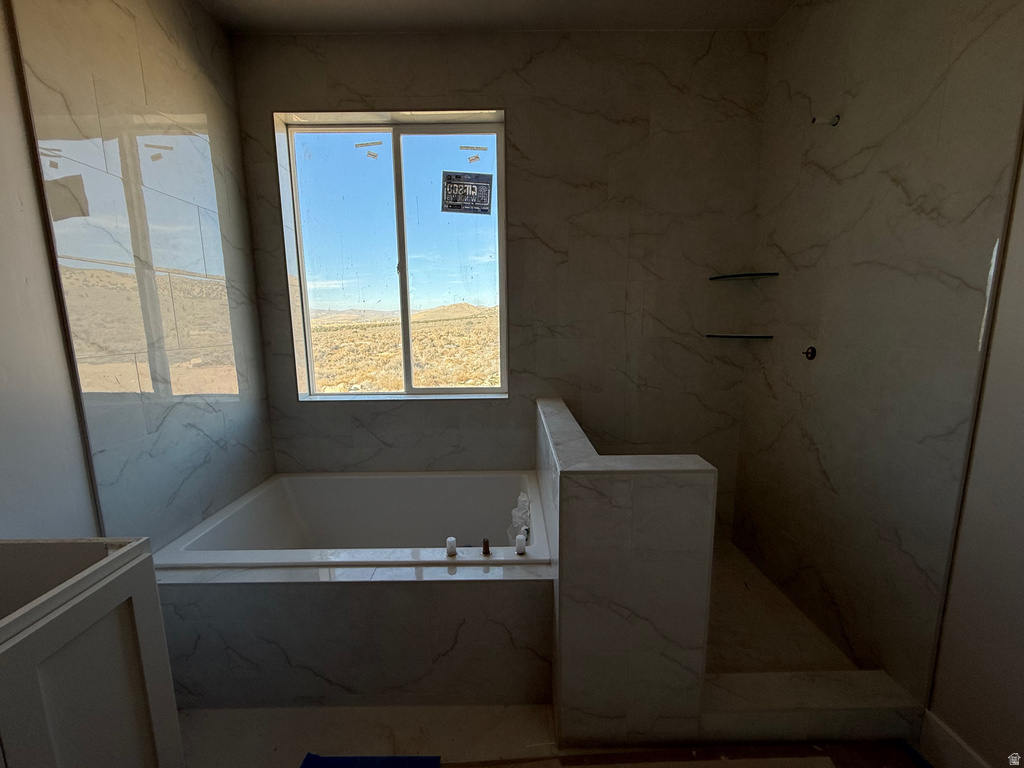 Full bath with a bath and a marble finish shower