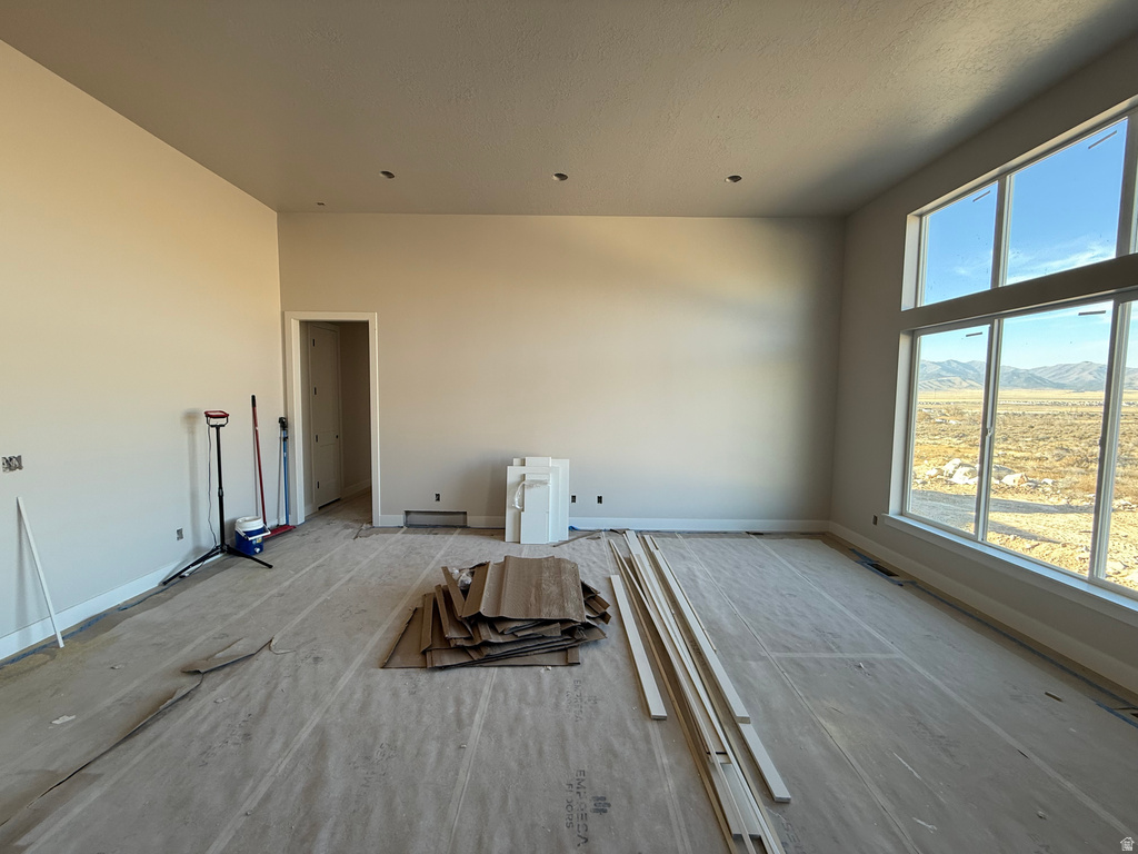 Empty room featuring baseboards and a mountain view