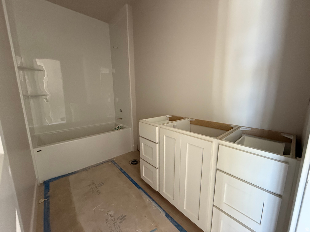 Bathroom featuring vanity and shower / tub combination