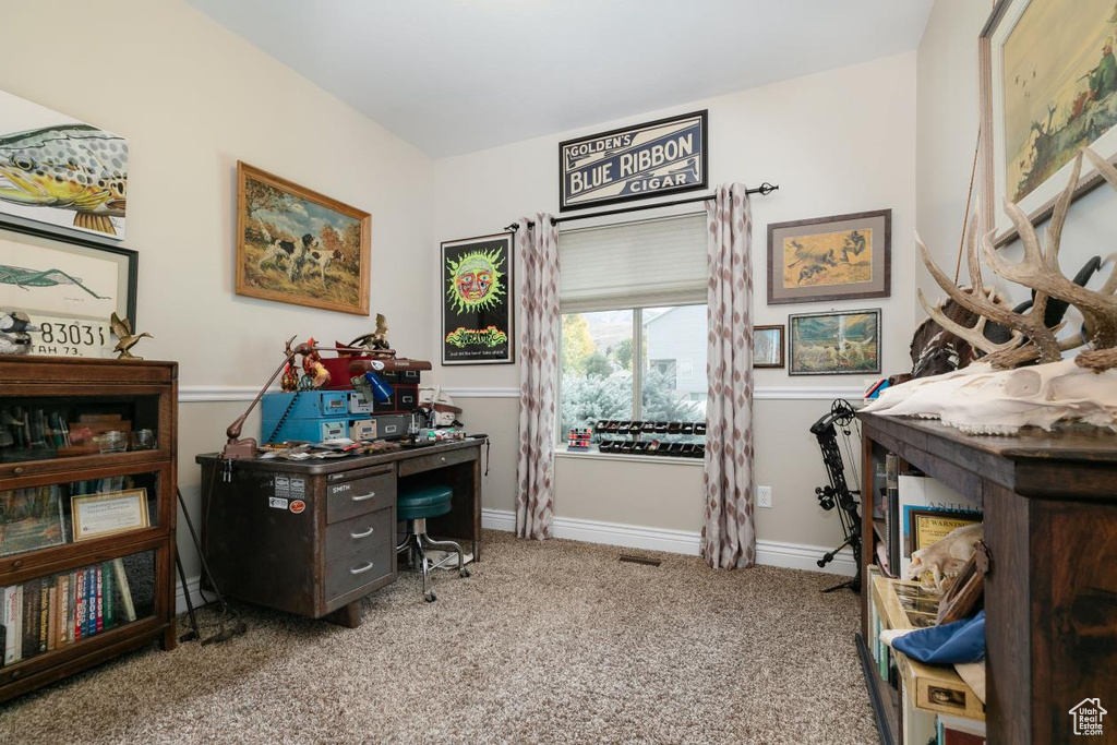 Office with light colored carpet and baseboards