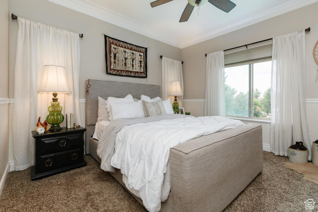 Bedroom featuring carpet floors, crown molding, and a ceiling fan