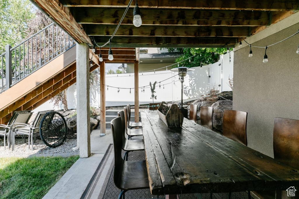 View of patio featuring a wooden deck and outdoor dining space