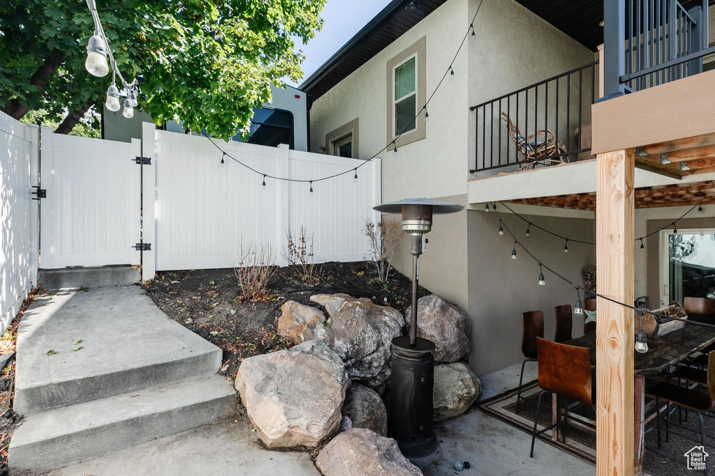View of yard featuring a gate and a balcony