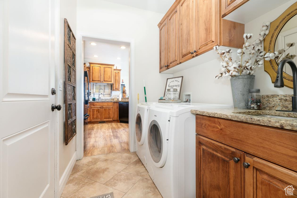 Washroom featuring cabinet space, independent washer and dryer, recessed lighting, and light tile patterned floors