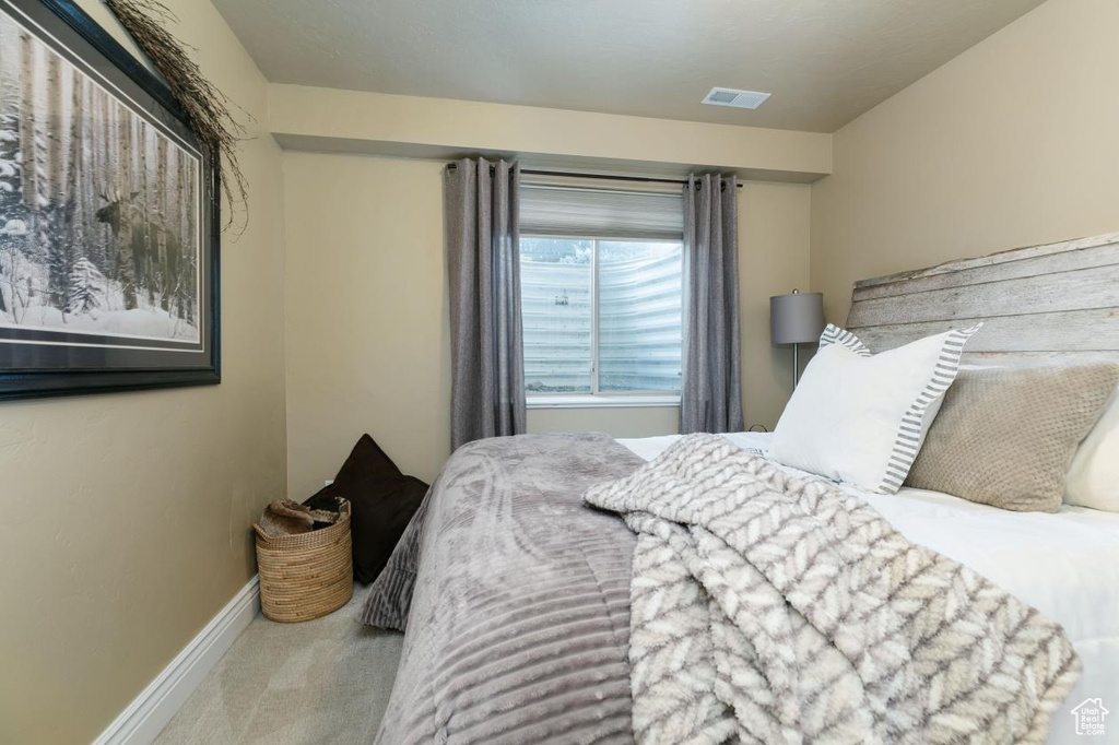 Carpeted bedroom with baseboards