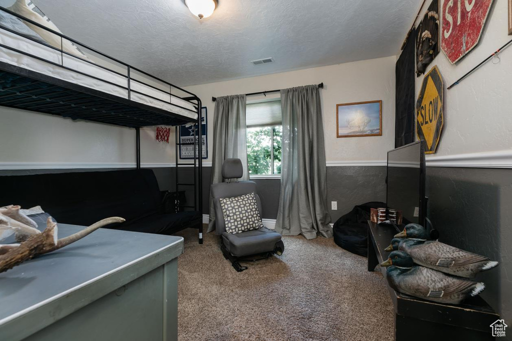 Carpeted bedroom featuring a textured ceiling
