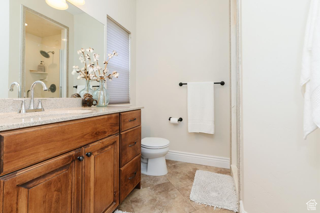Bathroom with vanity, a stall shower, and light tile patterned floors