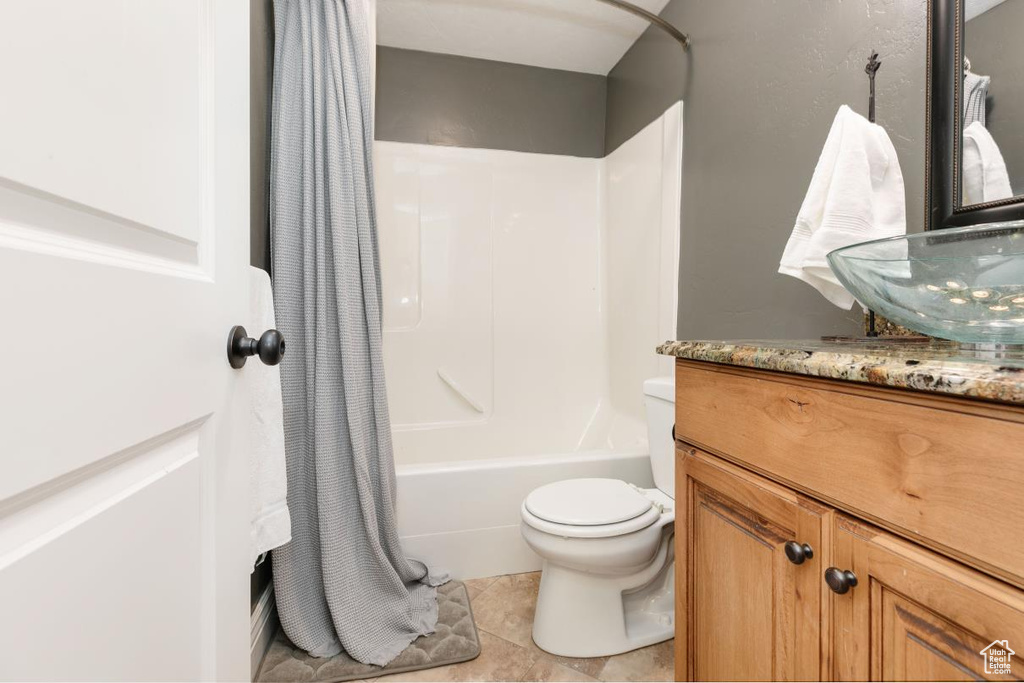 Full bathroom featuring vanity, shower / bath combo, and light tile patterned floors