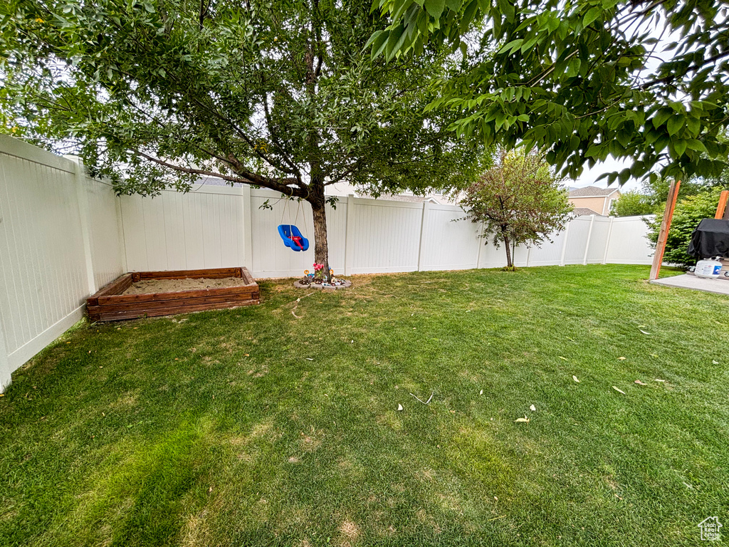 Fenced backyard featuring a garden