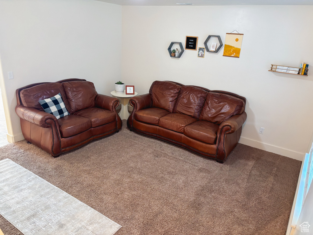 Living room featuring carpet floors and baseboards