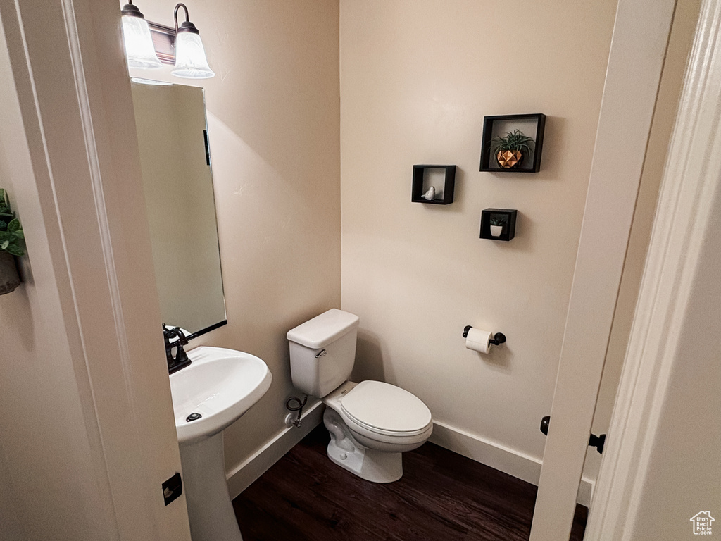 Bathroom featuring dark wood-style floors and baseboards