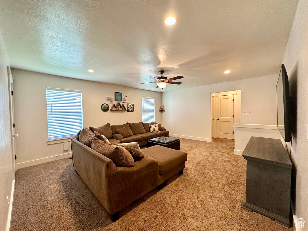 Carpeted living area with recessed lighting, ceiling fan, and a textured ceiling