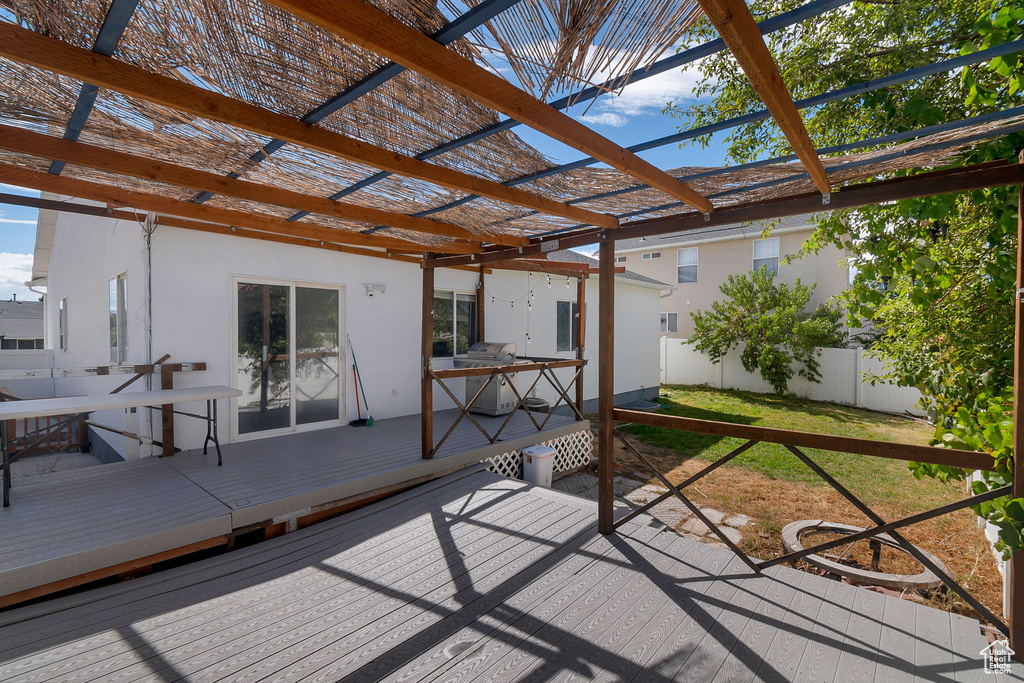 Sunroom / solarium with healthy amount of natural light and a deck