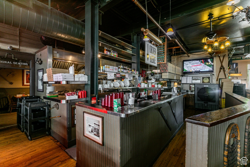 Kitchen featuring open shelves, dark wood-type flooring, and stainless steel countertops