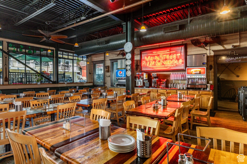 Dining room with ceiling fan and dark wood finished floors