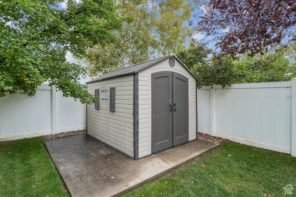 View of shed with a fenced backyard