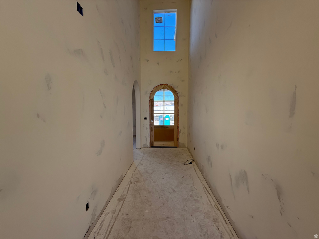 Hallway with a towering ceiling and arched walkways