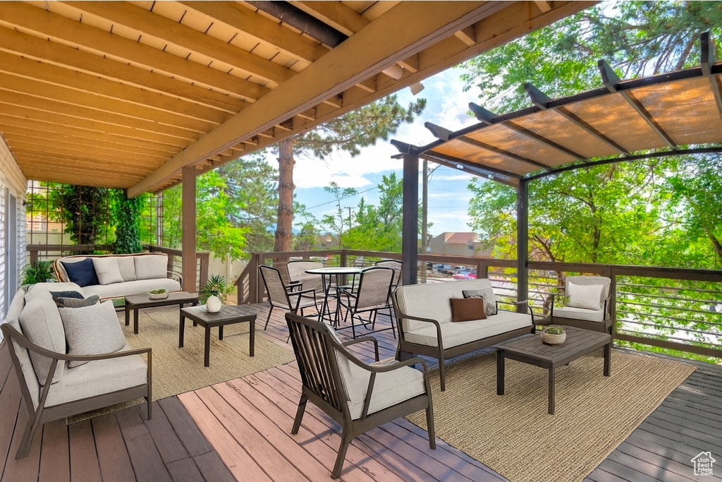 Wooden terrace featuring an outdoor hangout area and outdoor dining area