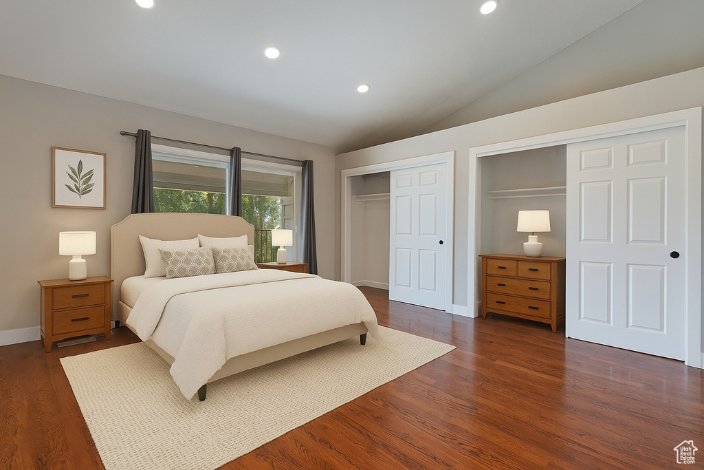 Bedroom with recessed lighting, vaulted ceiling, dark wood-type flooring, and multiple closets