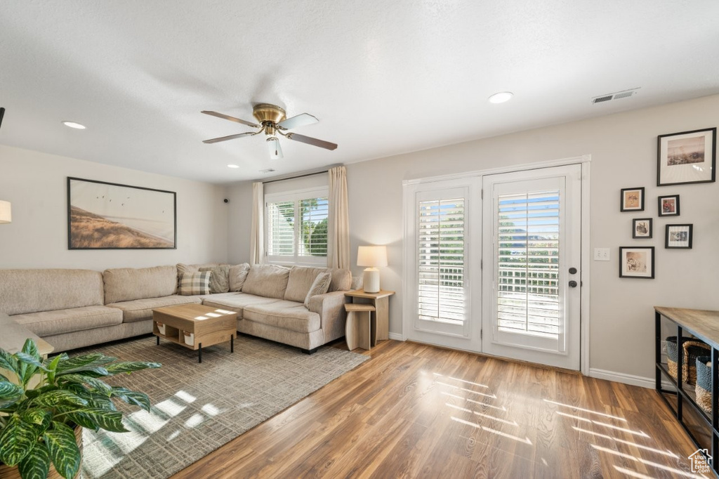 Living room featuring wood finished floors, a ceiling fan, and recessed lighting