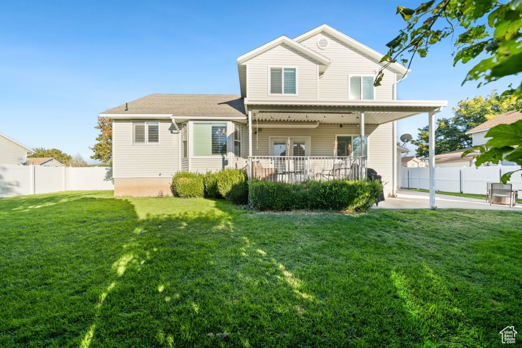 Back of house featuring a fenced backyard and a porch