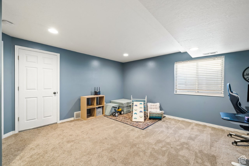 Playroom with carpet, recessed lighting, and a textured ceiling